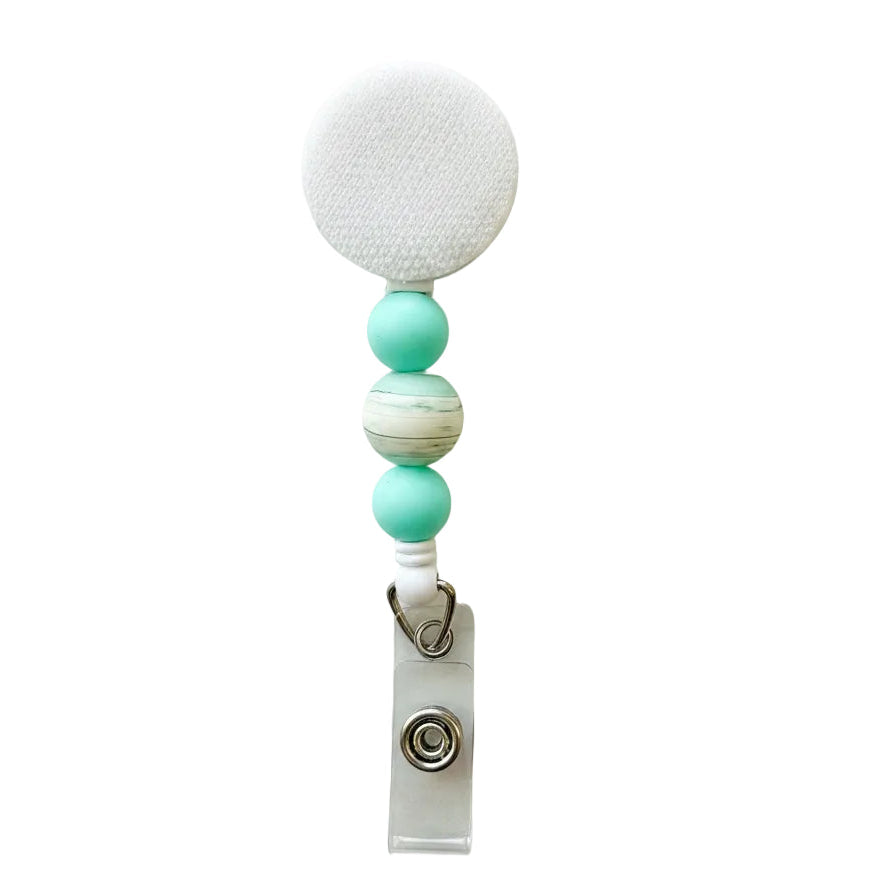 Mint Marble beaded badge reel featuring mint silicone beads, a white marble-pattern center bead, retractable badge reel, and clear badge holder attachment.