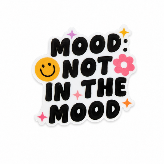 MOOD: NOT IN THE MOOD plastic add-on with bold black text, smiley face, pink flower, and stars, compatible with interchangeable badge reel bases.