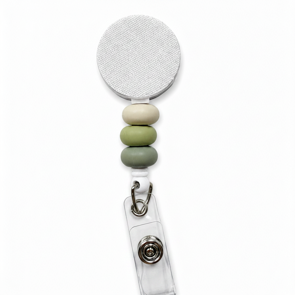 Moss and Stone badge reel featuring cream, sage green, and moss green decorative beads on a white retractable badge reel. Neutral beaded work badge accessory.
