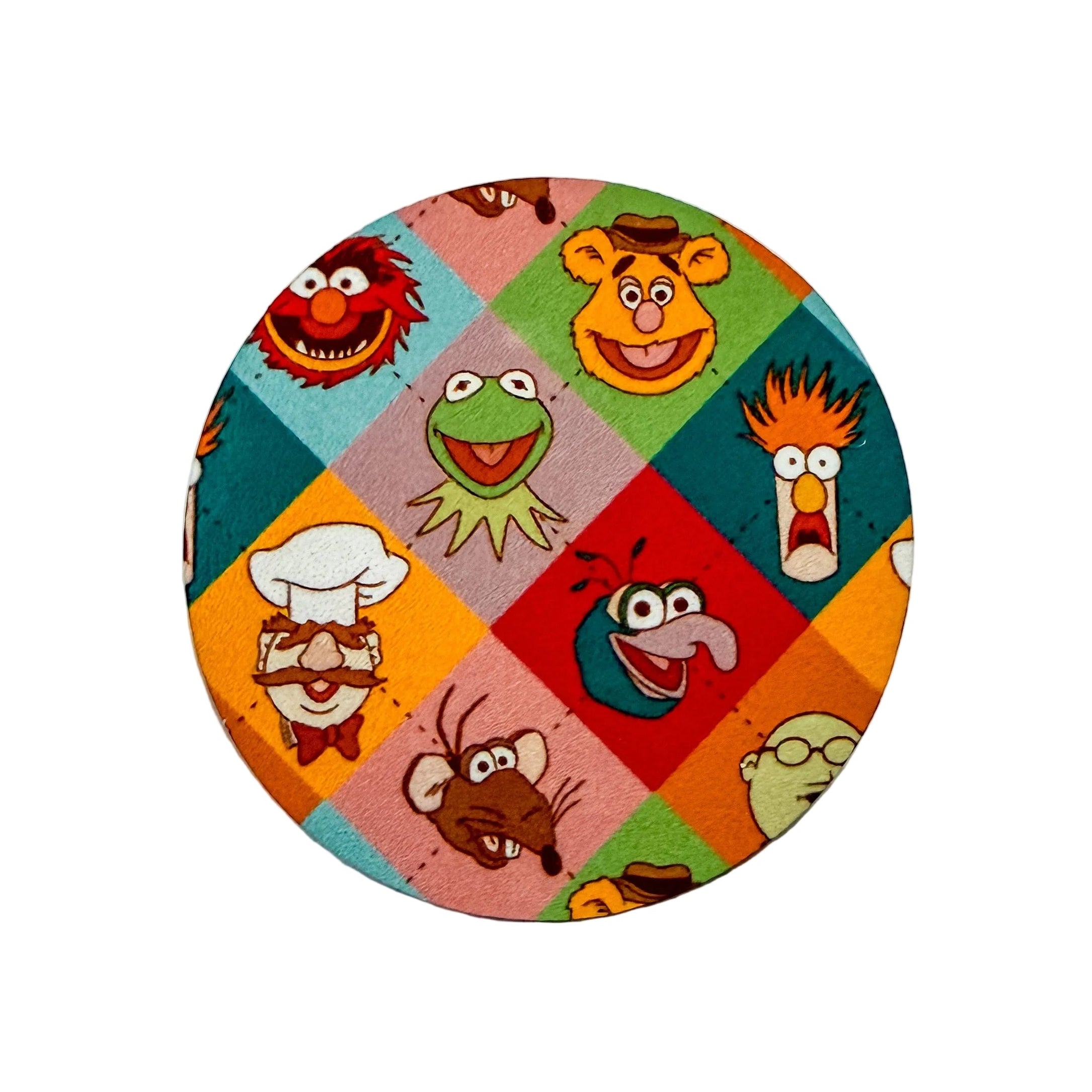 Muppets-themed hard board add-on featuring colorful character faces, compatible with interchangeable badge reel bases. Cute character badge topper and work badge accessory.