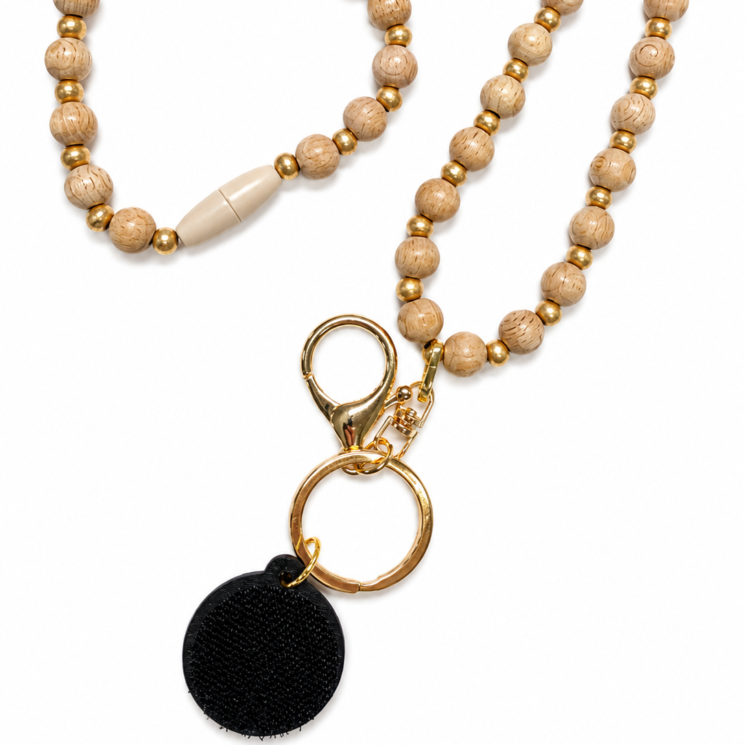 Natural wood and metallic gold beaded interchangeable lanyard with gold-tone hardware and attached hook-and-loop disc, compatible with Badge Beauties interchangeable hardboards and plastic add-ons.