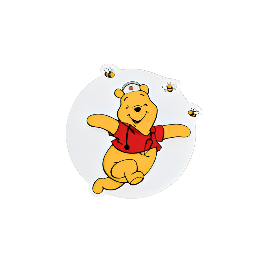 Cute nurse bear plastic add-on featuring a smiling bear wearing red scrubs, a nurse cap, and stethoscope with bees, compatible with interchangeable badge reel bases and perfect as a nurse badge accessory