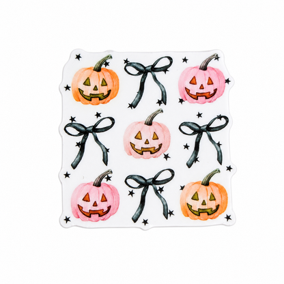 Pastel pumpkin and black bow plastic add-on featuring pink and orange jack-o'-lantern pumpkins with ribbon bows and stars, compatible with interchangeable badge reel bases, cute Halloween accessory