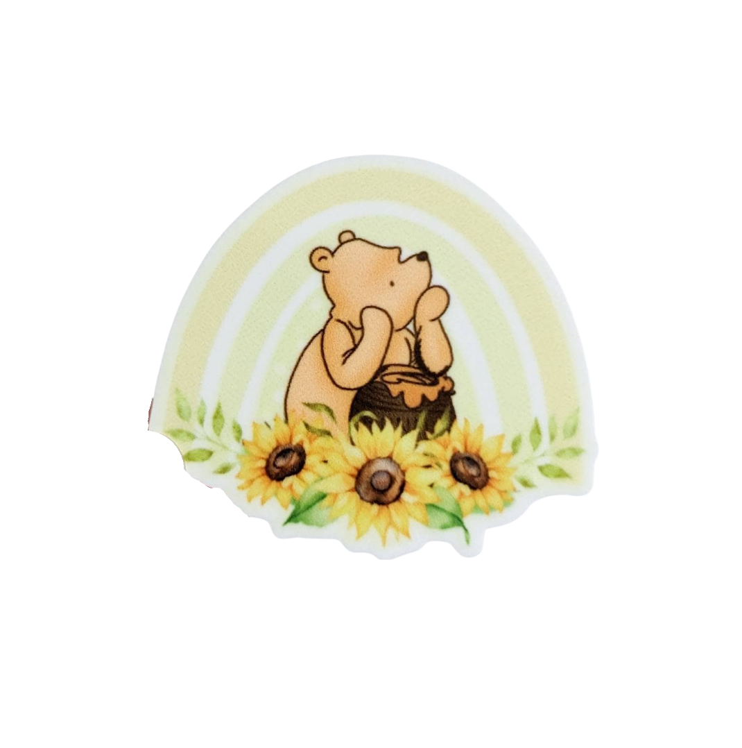 Pooh bear plastic add-on with cute bear, honey pot, yellow rainbow, and sunflowers, compatible with interchangeable badge reel bases.