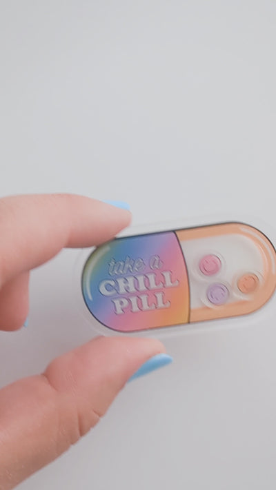TAKE A CHILL PILL plastic shaker add-on with smiling shaker pieces inside a colorful capsule design