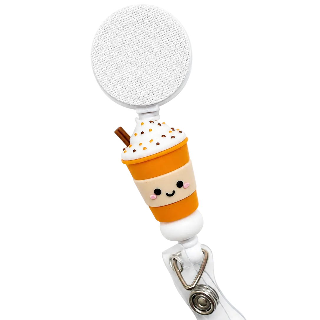 Pumpkin Spice Drink badge reel featuring a smiling pumpkin spice coffee cup with whipped cream, sprinkles, retractable badge reel, and secure badge holder attachment.