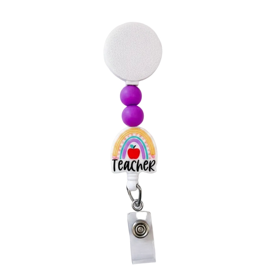 Rainbow Teacher interchangeable badge reel with purple silicone beads and colorful rainbow teacher design on a white retractable beaded badge reel.