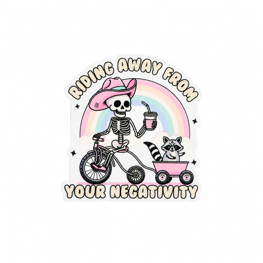RIDING AWAY FROM YOUR NEGATIVITY plastic add-on featuring a skeleton in a pink cowboy hat riding a bicycle with a raccoon in a wagon under a rainbow, compatible with interchangeable badge reel bases