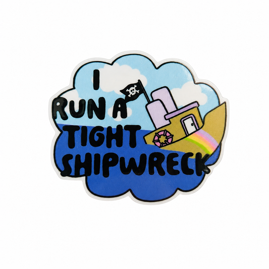 Plastic add-on featuring the text "RUN A TIGHT SHIPWRECK" with a colorful pirate ship, rainbow, clouds, and ocean waves, compatible with interchangeable badge reel bases and ideal as a funny coworker accessory.