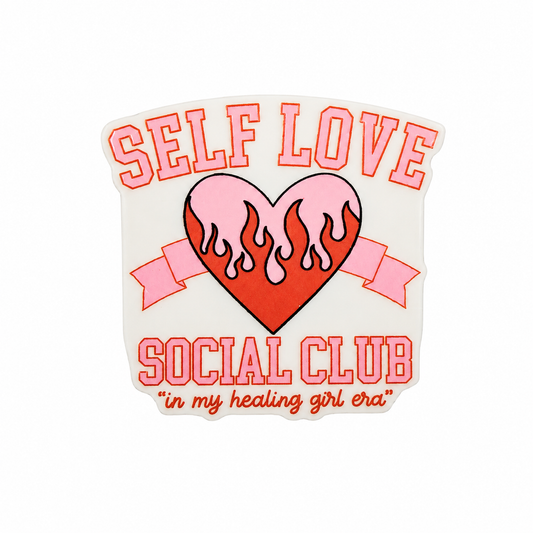 SELF LOVE SOCIAL CLUB "in my healing girl era" plastic add-on featuring a pink flaming heart and ribbon, compatible with interchangeable badge reel bases.