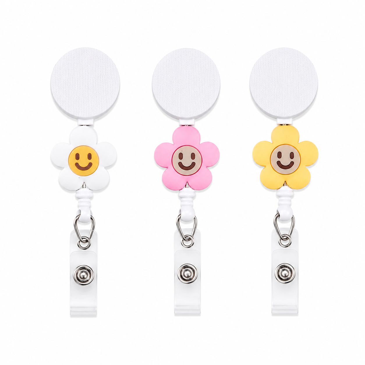 Smiley daisy flower badge reel with white retractable badge reel, interchangeable floral topper available in white, pink, and yellow, cute work badge accessory.