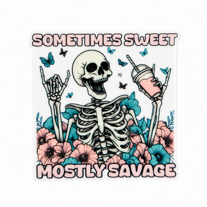SOMETIMES SWEET MOSTLY SAVAGE plastic add-on featuring a smiling skeleton with pink and blue flowers, butterflies, and a pink drink, compatible with interchangeable badge reel bases