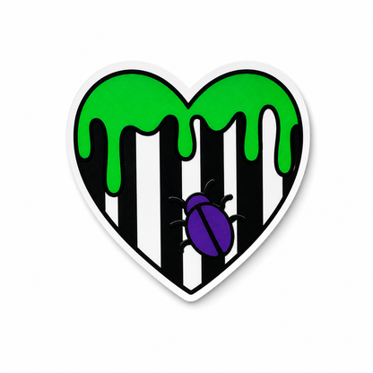 Striped beetle-inspired heart plastic add-on with green dripping details compatible with interchangeable badge reel bases