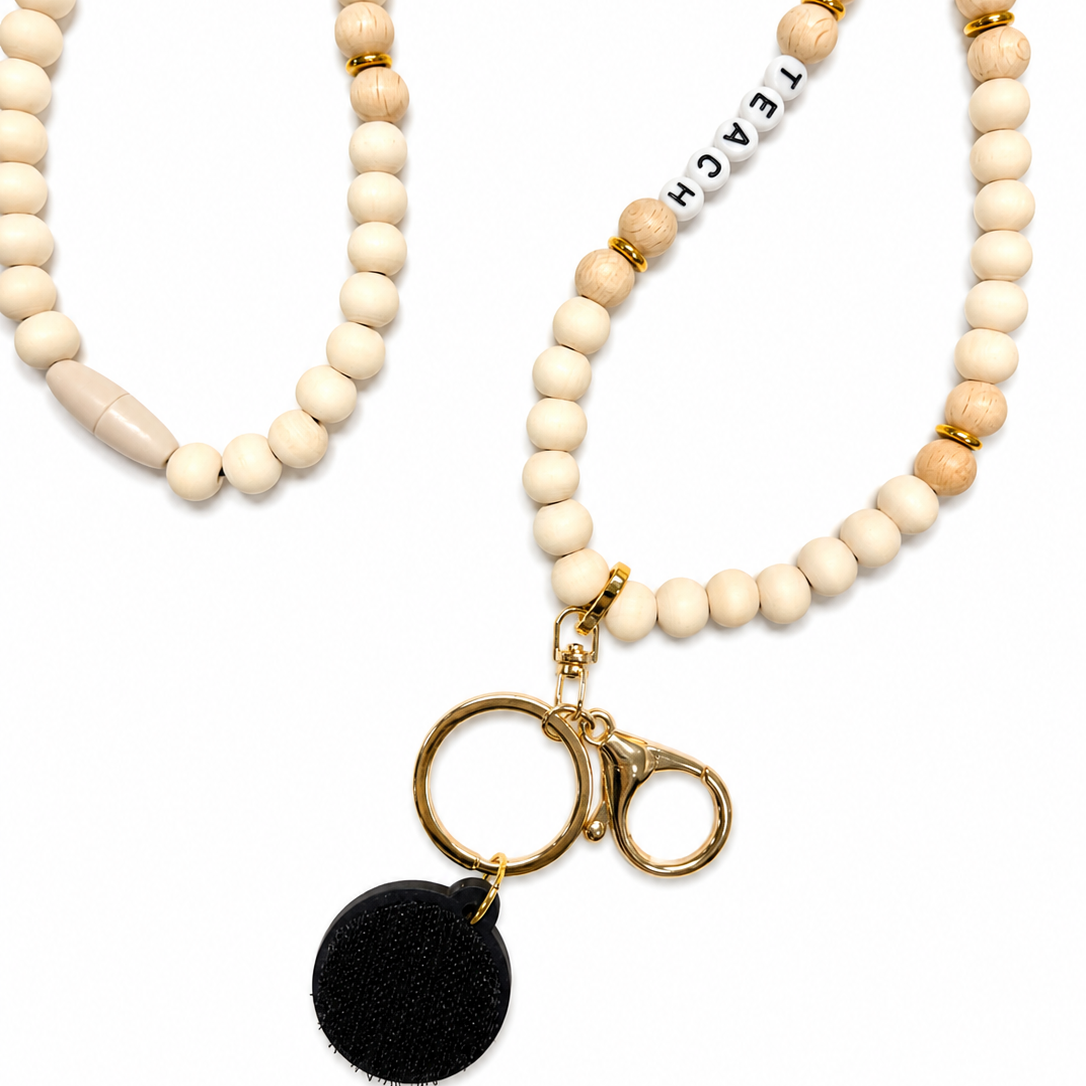 "Teach" interchangeable beaded lanyard with ivory wood beads, gold-tone hardware, and attached hook-and-loop disc, compatible with Badge Beauties interchangeable hardboards and plastic add-ons.