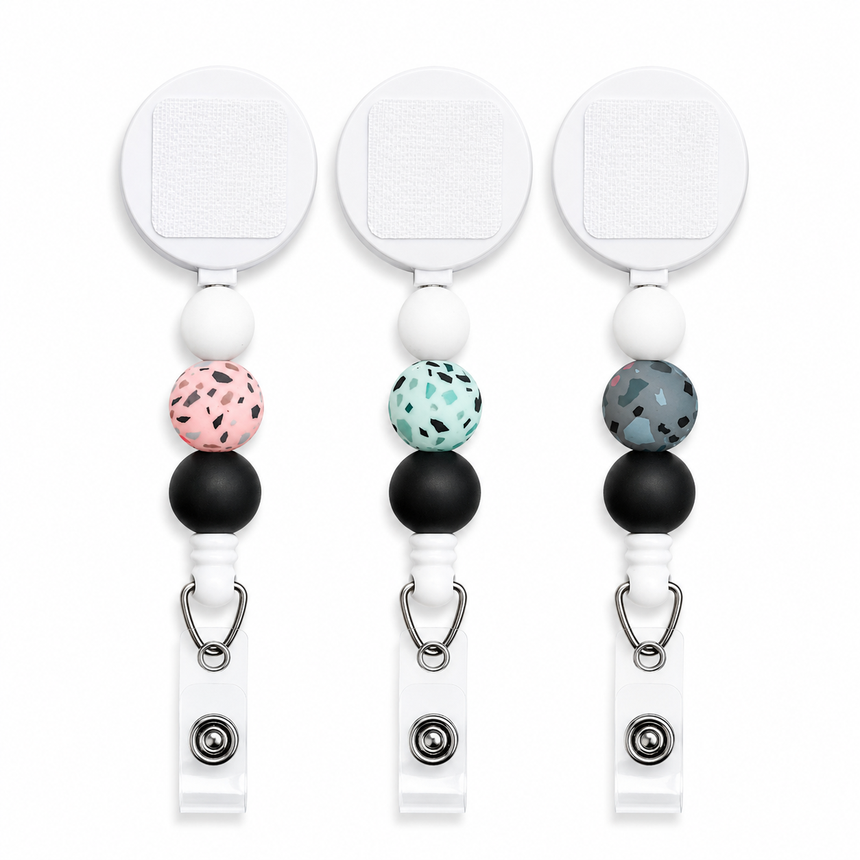 Terrazzo interchangeable beaded badge reel featuring modern speckled silicone beads in mint, blush, or gray with black accent beads and a retractable badge holder.