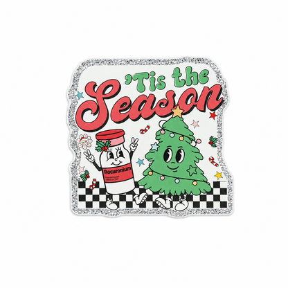 Plastic add-on featuring the text "'Tis the Season" with a smiling Christmas tree and Rocuronium bottle, compatible with interchangeable badge reel bases and perfect for healthcare holiday humor.