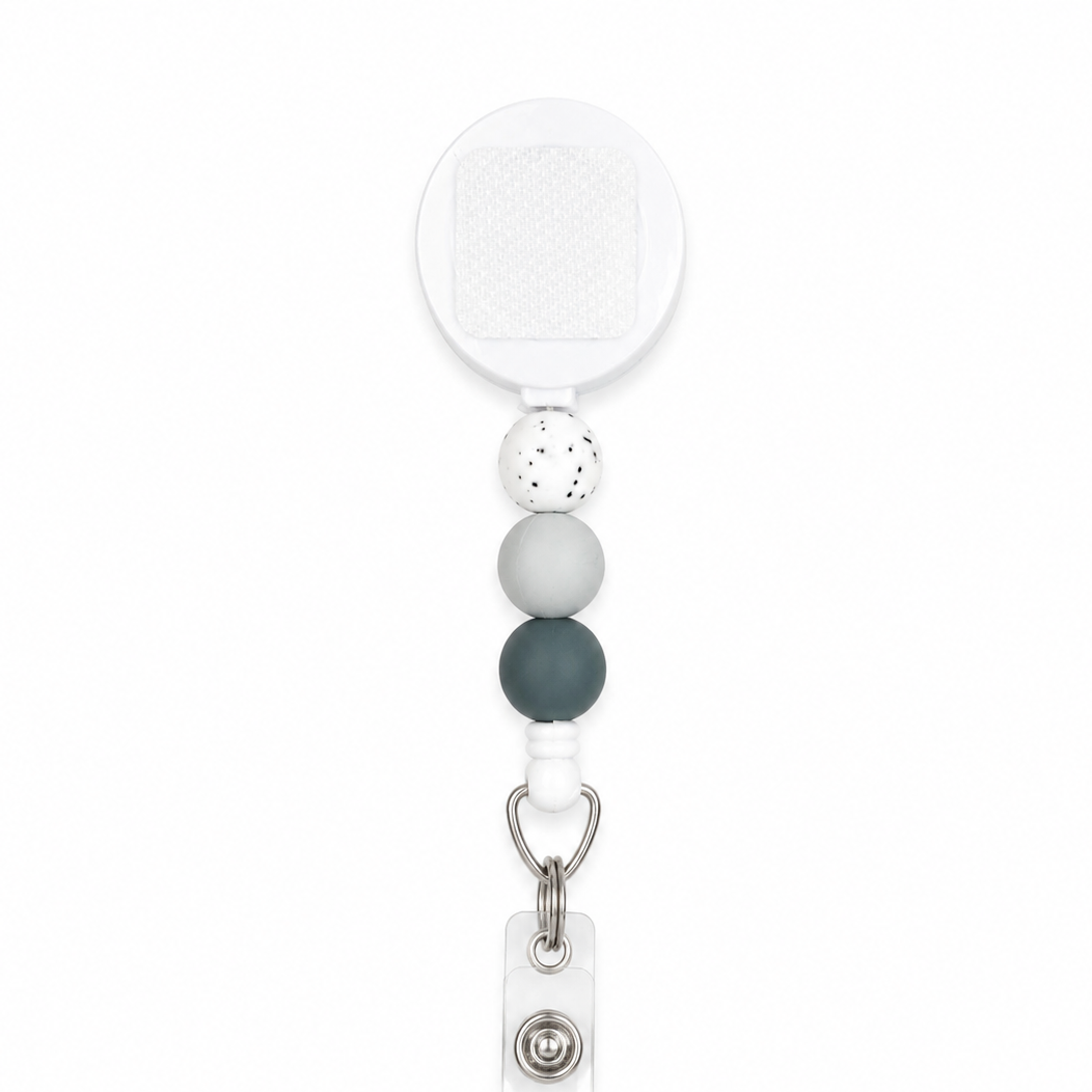 Winter evergreen beaded badge reel with white retractable reel, speckled white, light gray, and evergreen silicone beads, interchangeable work badge accessory.