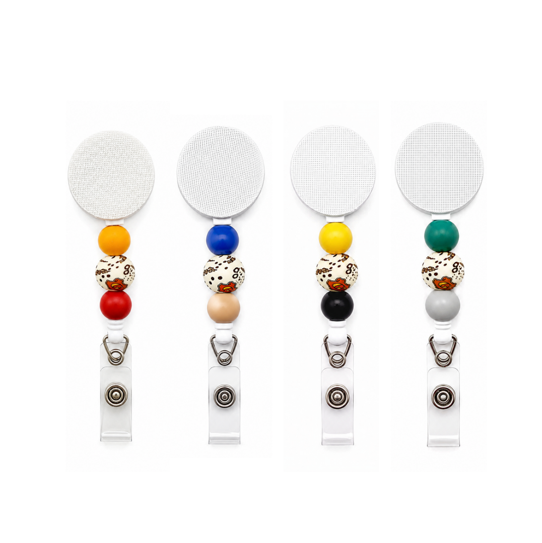 Wizard-inspired beaded badge reel featuring yellow and red silicone beads with a magical printed focal bead on a white retractable interchangeable badge reel.